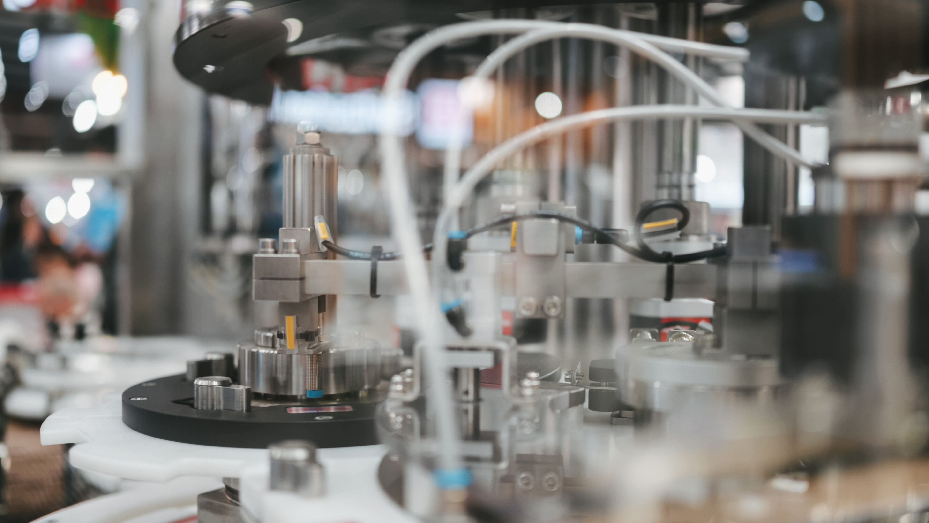 Robotic arms assembling small electronic components on a production line.